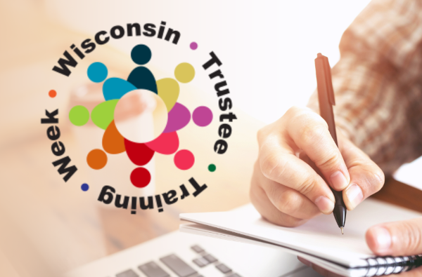 A hand writing in a notebook beside a circular multi-colored logo for "Wisconsin Trustee Training Week."